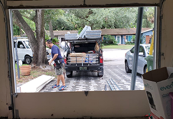 Exterior view of garage with new white garage door and tracks installed in Highland Park, TX