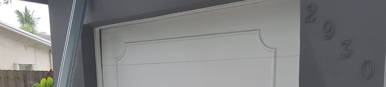 Exterior view of garage with new white garage door and tracks installed in Highland Park, TX