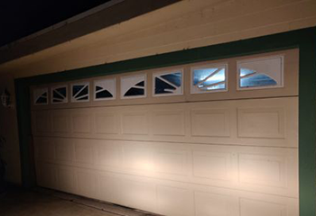 Front exterior of Dallas home showing newly installed steel panel garage door